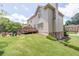 Well-manicured backyard with a patio and deck, providing an ideal setting for outdoor activities at 3574 Timberloch Trl, Snellville, GA 30039