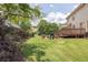 Grassy backyard featuring a patio and deck, perfect for outdoor living and entertaining at 3574 Timberloch Trl, Snellville, GA 30039