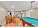 Basement with a pool table, dining table, and chairs with a sofa in the background at 3574 Timberloch Trl, Snellville, GA 30039