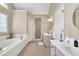 Spacious bathroom with a tub, double vanities, and a separate shower at 3574 Timberloch Trl, Snellville, GA 30039