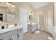Bathroom with double vanities, mirrors, and neutral decor accents at 3574 Timberloch Trl, Snellville, GA 30039