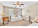 Bright bedroom with ceiling fan, neutral paint, and whimsical decor accents at 3574 Timberloch Trl, Snellville, GA 30039