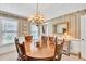 Warm dining room featuring a wooden table and chairs with decorative wallpaper at 3574 Timberloch Trl, Snellville, GA 30039