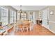Sunny dining area with hardwood floors, a table for six, and natural light at 3574 Timberloch Trl, Snellville, GA 30039