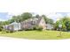 Suburban two-story home with well-manicured lawn, blue shutters, and lush trees adding curb appeal at 3574 Timberloch Trl, Snellville, GA 30039