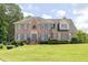 Inviting brick home with a well-kept lawn, classic blue shutters, and a decorative wreath on the front door at 3574 Timberloch Trl, Snellville, GA 30039