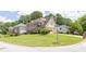 Spacious two-story residence with an attached garage, lush landscaping, and a well-maintained lawn at 3574 Timberloch Trl, Snellville, GA 30039