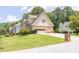 View of the house with 2 car garage, and well manicured lawn on a sunny day at 3574 Timberloch Trl, Snellville, GA 30039