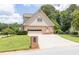 View of the house with 2 car garage, and well manicured lawn on a sunny day at 3574 Timberloch Trl, Snellville, GA 30039