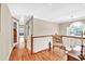 Bright hallway with hardwood floors, natural light, and decorative chair at 3574 Timberloch Trl, Snellville, GA 30039