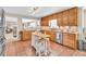 Well-lit kitchen with wood cabinets, an island, stainless appliances, and a cozy ambiance at 3574 Timberloch Trl, Snellville, GA 30039
