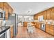 Charming kitchen with wood cabinetry, an island, stainless appliances, and tile flooring at 3574 Timberloch Trl, Snellville, GA 30039