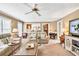 Comfortable living room with plush seating, ceiling fan and views to the kitchen at 3574 Timberloch Trl, Snellville, GA 30039