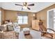 Comfortable living room featuring a ceiling fan, neutral tones, and inviting furnishings at 3574 Timberloch Trl, Snellville, GA 30039