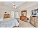 A main bedroom showing a tray ceiling, ceiling fan, and ensuite bathroom at 3574 Timberloch Trl, Snellville, GA 30039