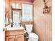 Cozy powder room featuring decorative wall accents and a window for natural light at 3574 Timberloch Trl, Snellville, GA 30039