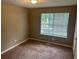 Cozy bedroom featuring plush carpeting, and a window at 3674 Riverchase Ter, Decatur, GA 30034