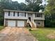 Two story home with stone accents and attached garages at 3674 Riverchase Ter, Decatur, GA 30034