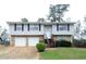 Charming split-level home featuring stone accents, two-car garage and a welcoming entrance staircase at 3674 Riverchase Ter, Decatur, GA 30034