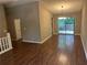 Open-concept living area with hardwood flooring, neutral walls and a sliding door access to deck at 3674 Riverchase Ter, Decatur, GA 30034