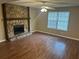 Living room has a stone fireplace and hardwood floors at 3674 Riverchase Ter, Decatur, GA 30034