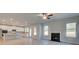 Open-concept living area with kitchen island, fireplace, and large windows providing natural lighting at 112 Felicity Pike, Locust Grove, GA 30248