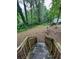 View of wooded backyard with fallen tree from the top of the back porch stairs at 2351 Carver Nw Dr, Atlanta, GA 30314