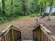 View of wooded backyard with fallen tree from the top of the back porch stairs at 2351 Carver Nw Dr, Atlanta, GA 30314