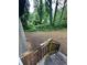 View of wooded backyard with fallen tree from the top of the back porch stairs at 2351 Carver Nw Dr, Atlanta, GA 30314
