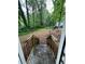 View of wooded backyard with fallen tree from the top of the back porch stairs at 2351 Carver Nw Dr, Atlanta, GA 30314