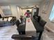 Open dining area with gray wood floors, granite table, and view into the kitchen at 2351 Carver Nw Dr, Atlanta, GA 30314