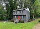 Lovely two-story home with a modern gray exterior, black shutters, and a striking red front door at 2351 Carver Nw Dr, Atlanta, GA 30314