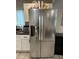 Stainless-steel LG refrigerator in kitchen with white cabinets and dark countertops at 2351 Carver Nw Dr, Atlanta, GA 30314