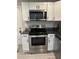 Kitchen with white cabinets, granite counters, and stainless-steel range and microwave at 2351 Carver Nw Dr, Atlanta, GA 30314