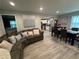 Spacious living room with hardwood-style floors flowing into dining area and view of kitchen with stainless steel appliances at 2351 Carver Nw Dr, Atlanta, GA 30314