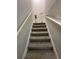 View up the carpeted staircase towards a tall vase and decorations at 2351 Carver Nw Dr, Atlanta, GA 30314
