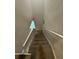 Long carpeted staircase with a white handrail going up towards a window at 2351 Carver Nw Dr, Atlanta, GA 30314