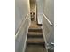 Carpeted stairs leading up to a storage area with shelves and an item on the side at 2351 Carver Nw Dr, Atlanta, GA 30314