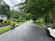 A quiet street featuring a mix of charming homes surrounded by mature trees and green lawns at 2351 Carver Nw Dr, Atlanta, GA 30314