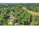 Aerial view of home surrounded by lush greenery and wooded views near the golf course at 3185 Country Club Nw Ct, Kennesaw, GA 30144