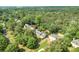 Aerial view of home nestled in a lush, green neighborhood with mature trees at 3185 Country Club Nw Ct, Kennesaw, GA 30144