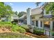 Back exterior of home with a large deck, screened porch and lush, landscaped yard at 3185 Country Club Nw Ct, Kennesaw, GA 30144