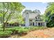 Back exterior view of home with large deck and wooded backyard, perfect for outdoor living at 3185 Country Club Nw Ct, Kennesaw, GA 30144