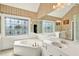Large bathroom with tub, white vanity and large mirror at 3185 Country Club Nw Ct, Kennesaw, GA 30144