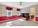 Bedroom featuring red and wallpapered accent walls, two windows with red valances, and carpeted floors at 3185 Country Club Nw Ct, Kennesaw, GA 30144