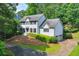 Classic two-story home with a landscaped front yard, featuring a circular driveway and attached two-car garage at 3185 Country Club Nw Ct, Kennesaw, GA 30144