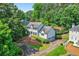 Stately two-story home with a manicured lawn, mature trees, and a circular driveway, offering curb appeal at 3185 Country Club Nw Ct, Kennesaw, GA 30144