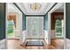 Inviting foyer with hardwood floors, decorative glass front door, and views into adjacent rooms with natural light at 3185 Country Club Nw Ct, Kennesaw, GA 30144
