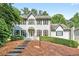 Stately two-story home with a covered entryway, lush landscaping, and a well-maintained front yard at 3185 Country Club Nw Ct, Kennesaw, GA 30144