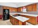 Kitchen with light countertops, wood cabinets, and island cooktop at 3185 Country Club Nw Ct, Kennesaw, GA 30144
